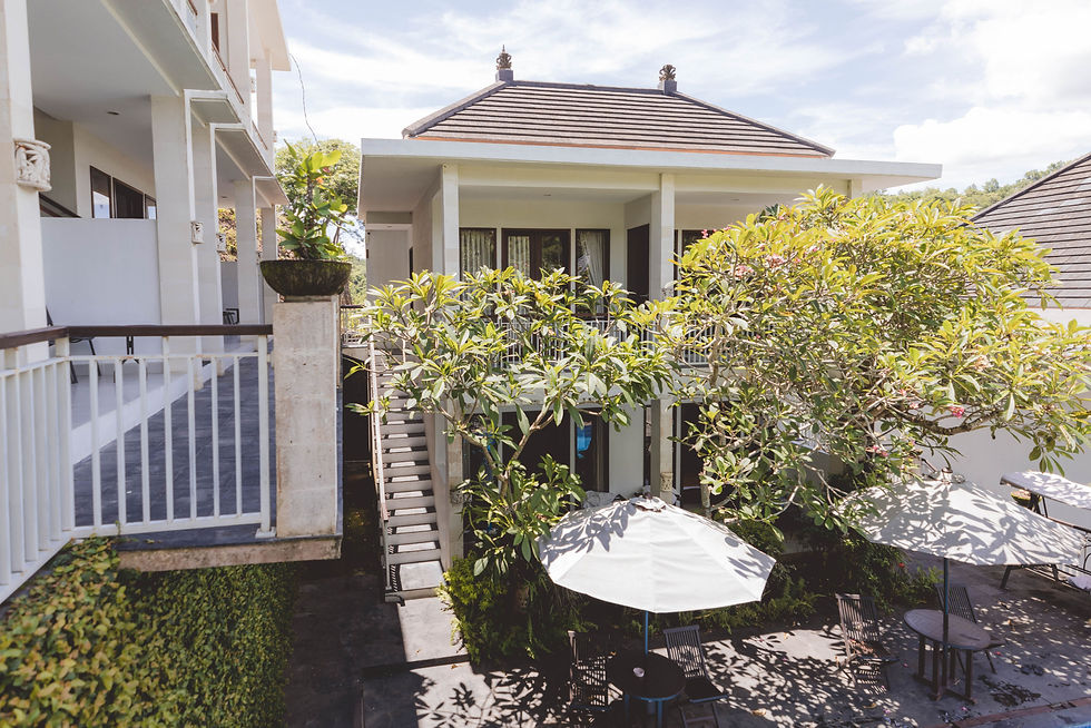 Eye-level view of Dewi Villa Padangbai entrance surrounded by lush greenery