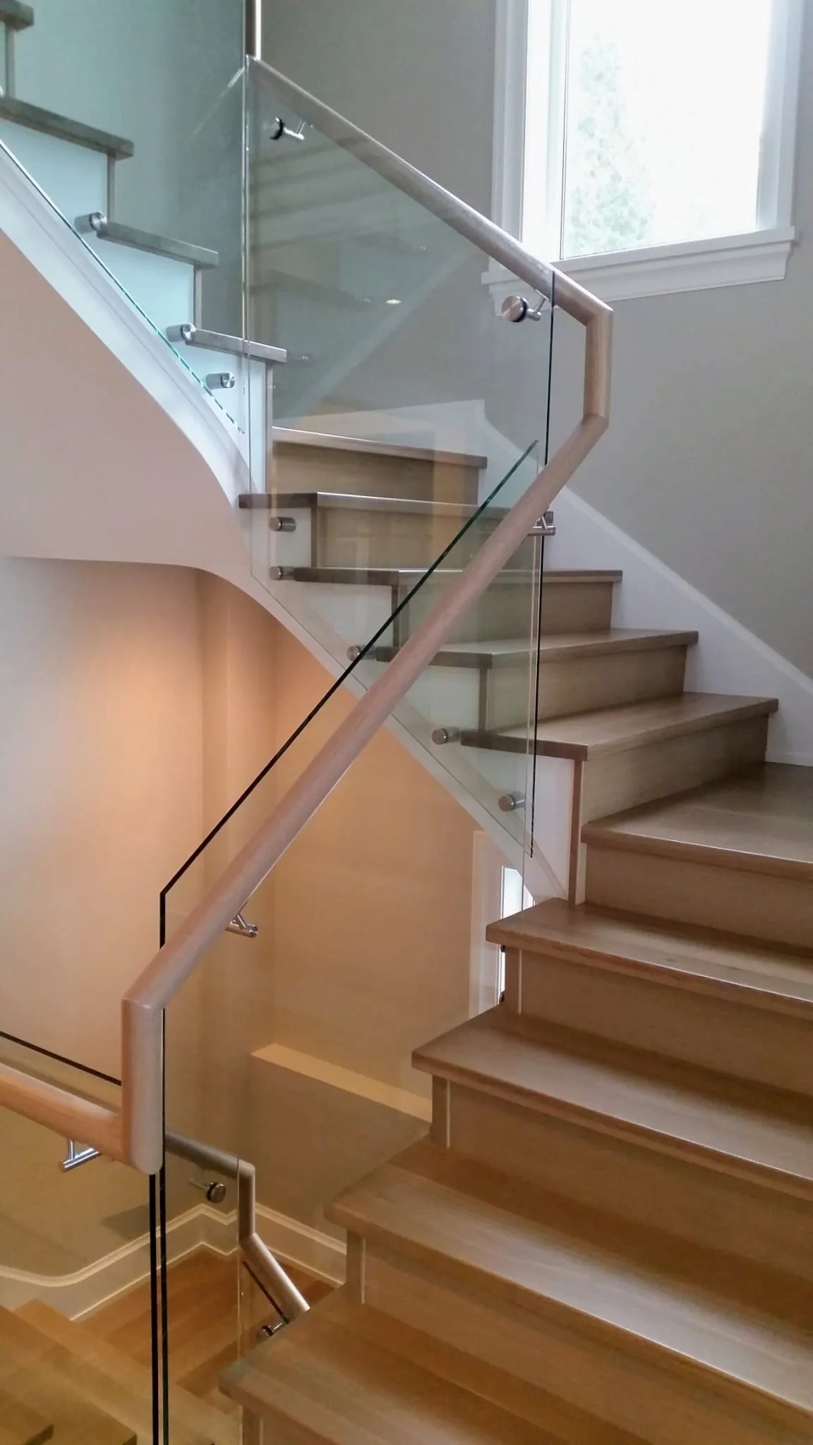 Custom interior modern glass railing with oak handrail in vancouver home