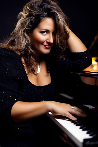 Nicole Zuraitis color portrait at piano smiling.jpeg
