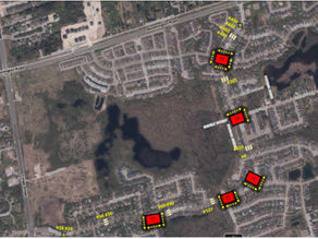 Aerial map showing locations of traffic calming measures in a neighborhood. Red "TT" markers and white roads are highlighted.