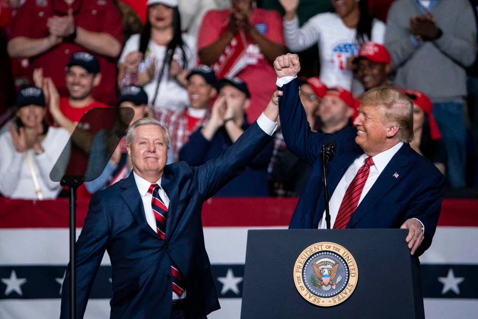 Lindsey Graham (left) with Donald Trump during a campaign rally for Graham’s reelection in February 2020. PHOTO: EPA