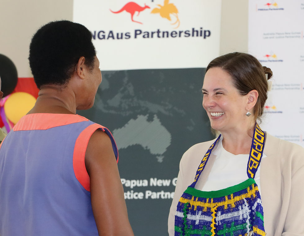 Australian High Commission Minister-Counsellor Elizabeth Le Bas presenting certificates to graduates of the Buimo Correctional Institution pre-release training programme.