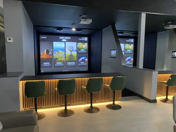 Modern indoor golf simulator at Ashbury Resort, ideal for practice and fun.