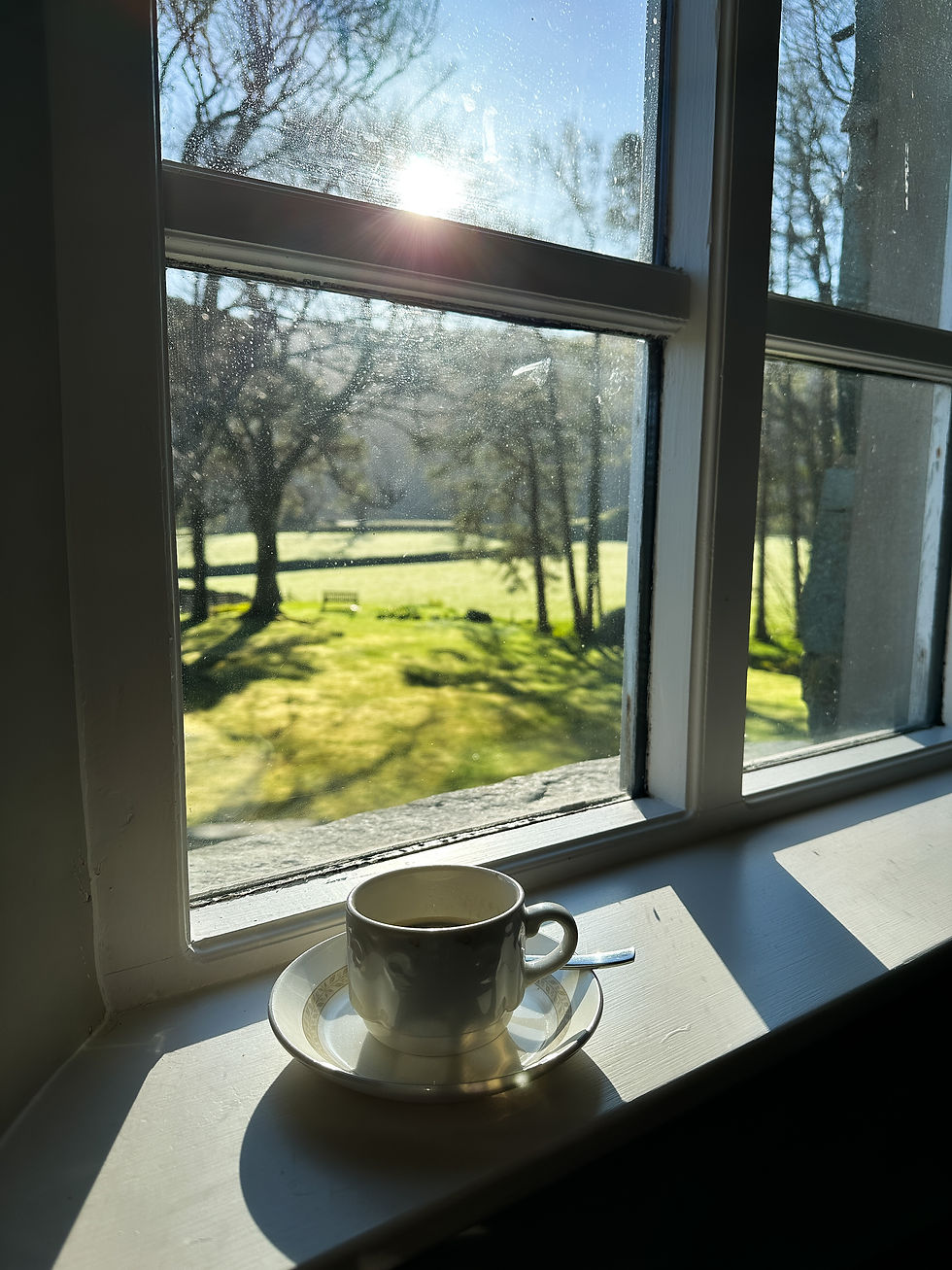 In Lake District. Tea cup resting on windowsill, Barrowdale Gate Hotel, Grange - silence and mental health reflection