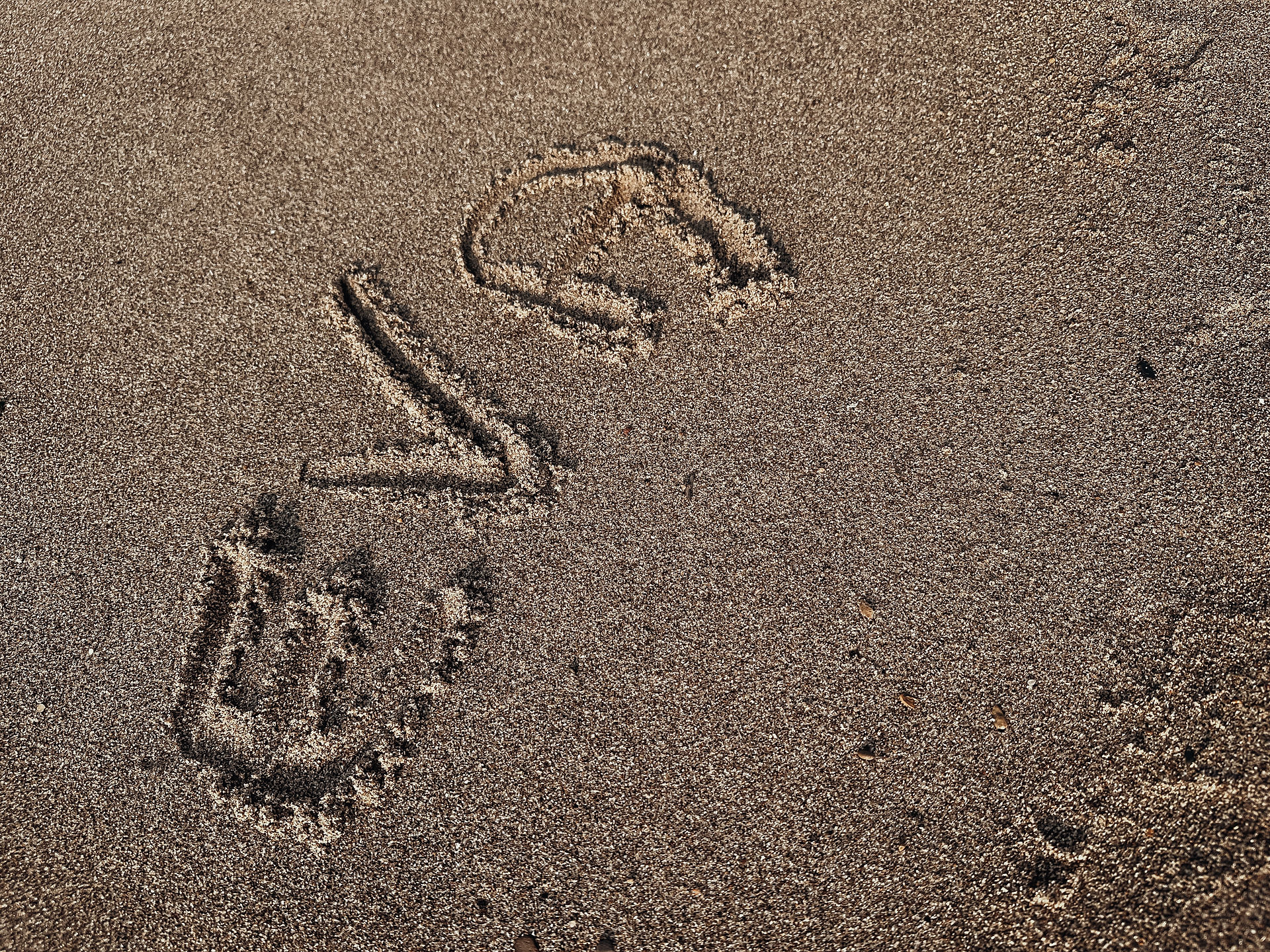 Sea sand and name written in the sand..Eva