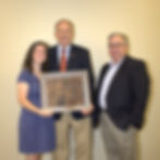 Ron Carter holding a cowhide plaque from the ACA
