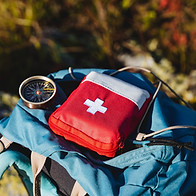 Compass first aid kit are in a backpack, a navigator in the taiga, a first aid kit in emer