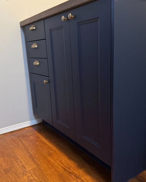 Dark blue IKEA home office cabinets with drawers and doors installed in a hallway in St. Albert, Alberta