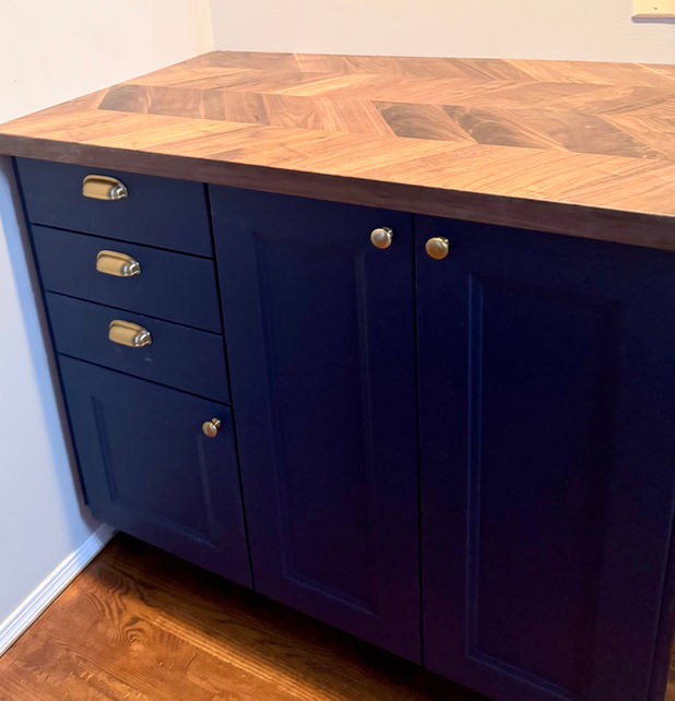 Custom navy blue cabinet installation with wood countertop in St. Albert