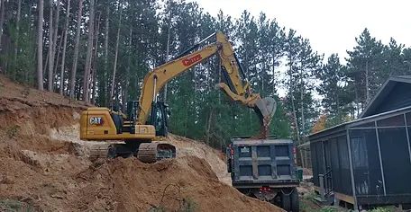 Cripe Excavating removing fill material from a backyard in Fall Creek WI.webp
