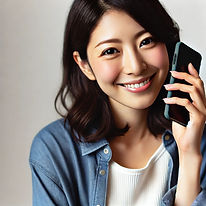 DALL·E 2024-11-11 21.36.35 - A Japanese woman holding a smartphone to her ear, smiling nat