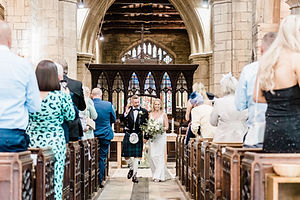 Bride and Groom walking down aisle