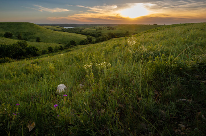 Flint Hills Kansas at sunset with layered hills and glowing horizon