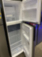 Open, empty refrigerator in a store setting Removed & Recycled by Junk Value in SG