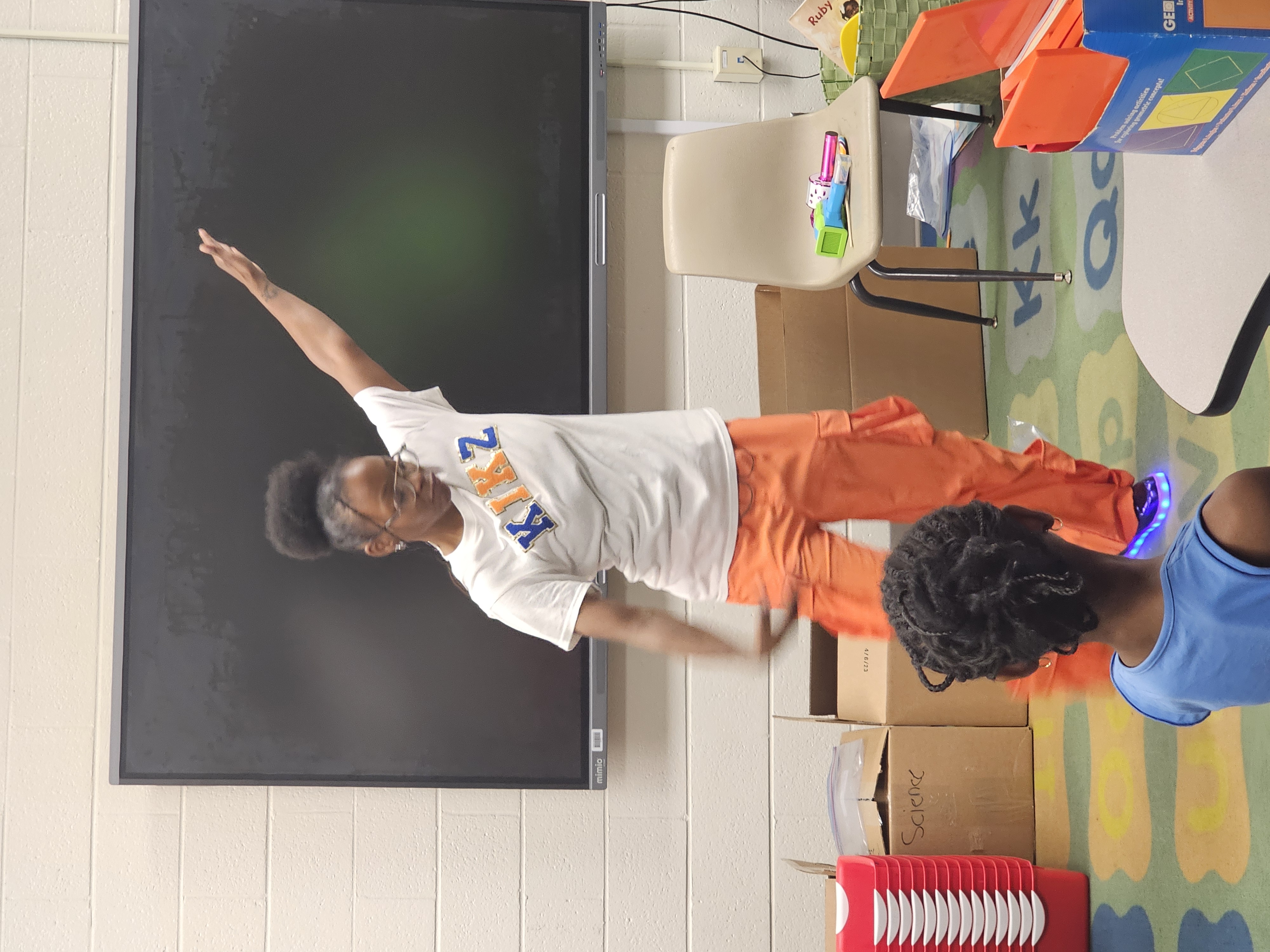 Kikz explains the next activity to the boys and girls at Cascade Elementary's Career Day