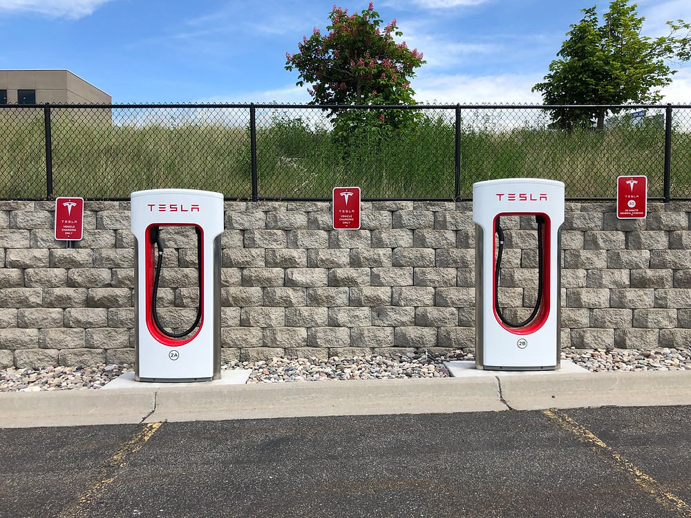 Tesla car chargers in a parking lot.