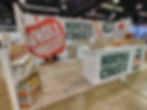 North Coast Organic is a primarily white exhibit with large green and red print and images throughout