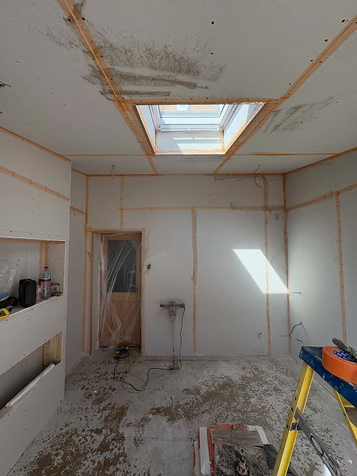 Room lined with plasterboard and a skylight ready for plastering