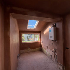 Small room with a skylight and freshly plastered walls