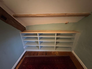 Fitted timber shelving built into an alcove to suit an awkward space