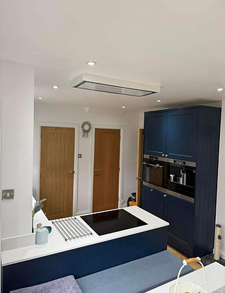 Navy fitted kitchen with built-in oven, coffee machine and extractor hood