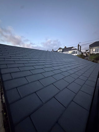 Slate roof tiles fitted on a South West property at dusk