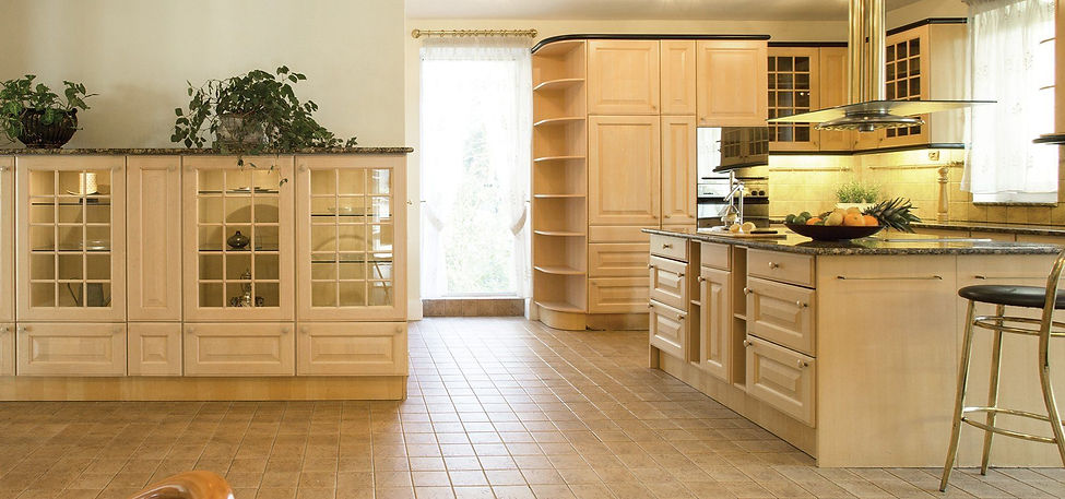 Fitted kitchen with glass-panelled units and central island in Nottingham home