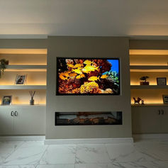 Fitted media wall with a television and an electric fire