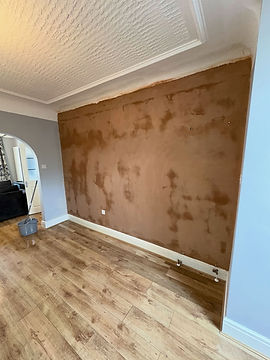 Newly plastered wall and doorway in a home with a staircase