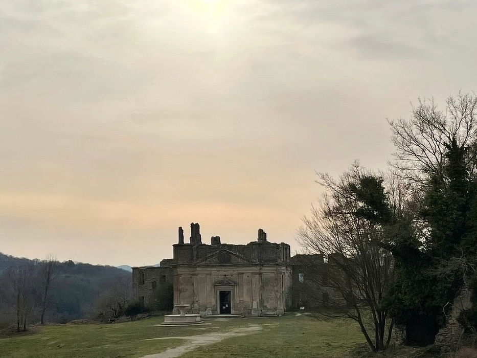 Ruins of Antica Monterano ghost town in a regional nature reserve in Lazio, Italy, with abandoned church façade and countryside landscape.