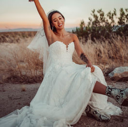 Bride in Essense of Australia Wedding Dress Holding Bouquet in Desert