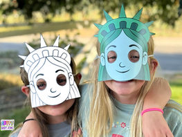 Girls wearing Statue of Liberty masks.