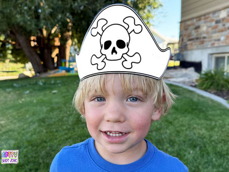 Boy wearing paper pirate hat.