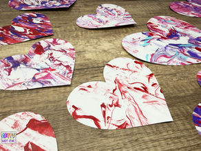 Shaving Cream Marbled Hearts on wood table.