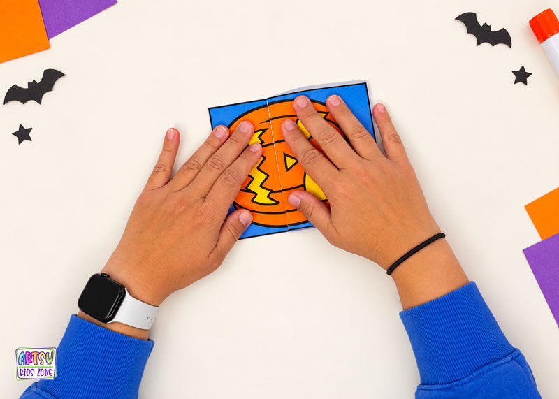 Folding the surprise pumpkin craft for kids.