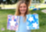 Girl holding completed Water Gun Paintings.