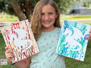 Girl holding completed Dragon water gun paintings.