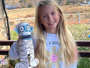 Girl holding Mummy Paper Puppet.