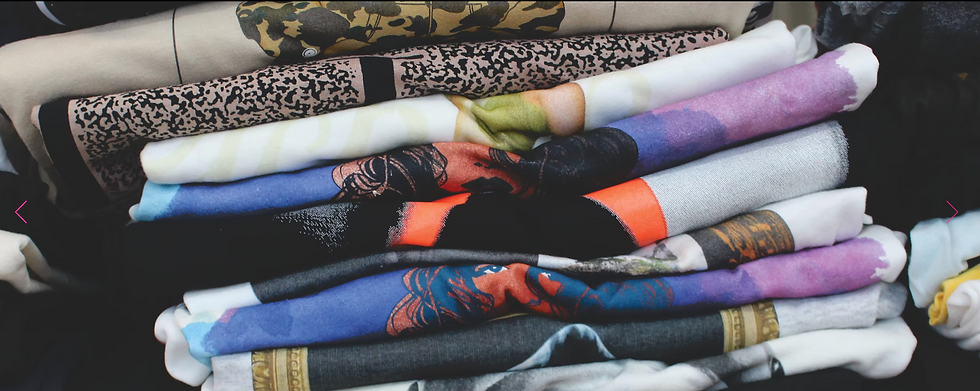 Eye-level view of a rack with various custom printed cotton shirts