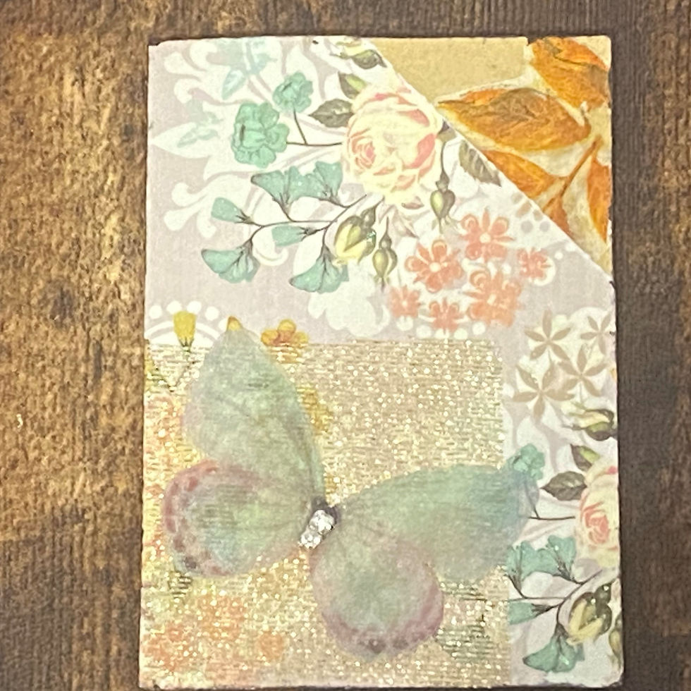mixed media art card with a green fabric butterfly moth on autumn floral paper and shimmering gold ribbon