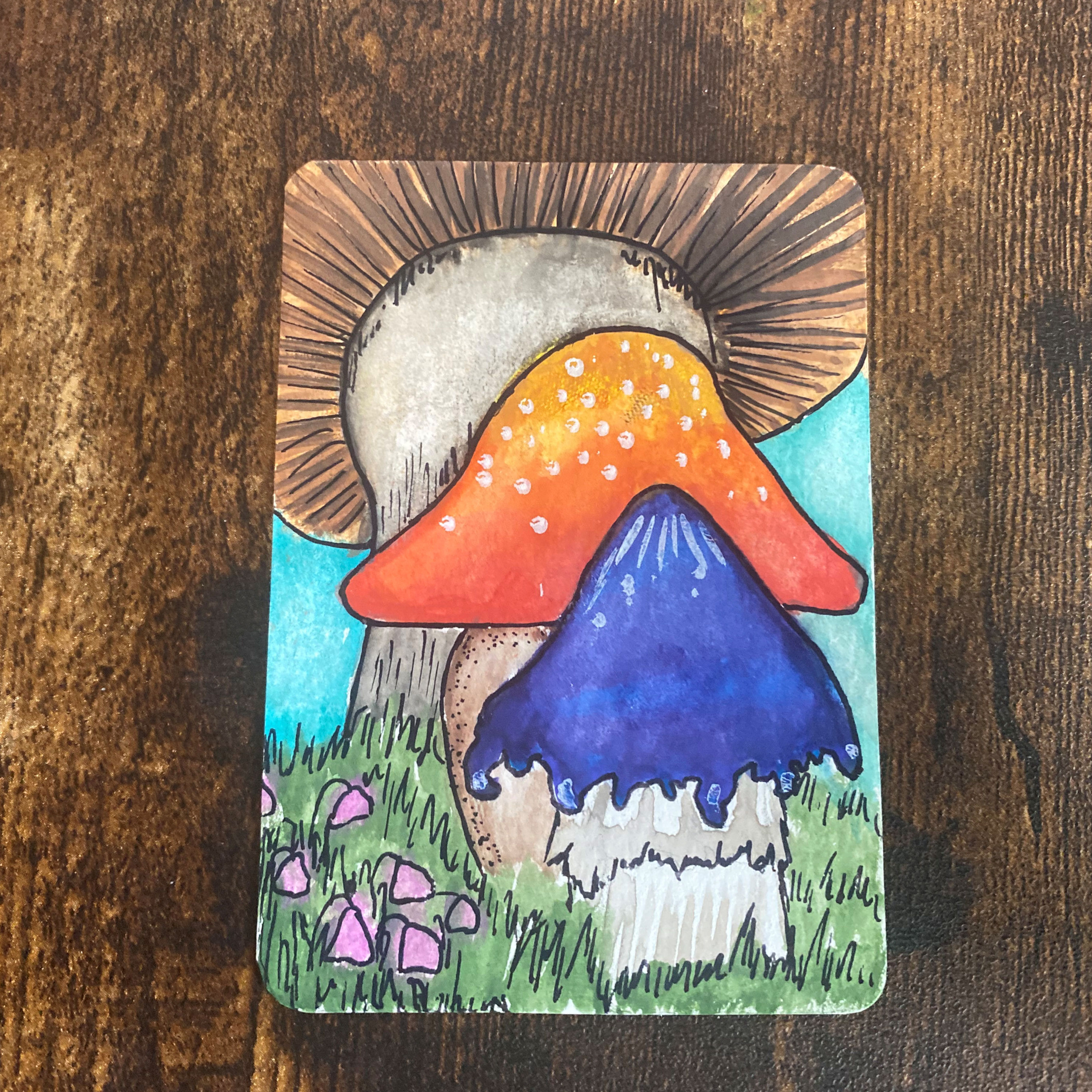 mushroom trio watercolour painting with a brown, blue and red mushroom