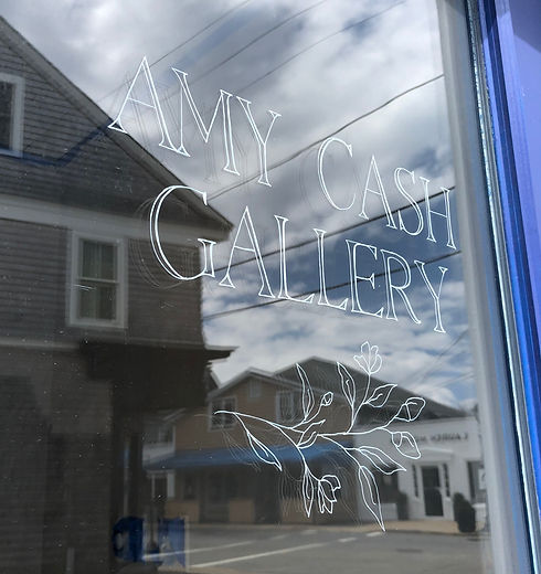 Stenciled letters "Amy Cash Gallery" on a glass door.