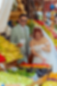 Groom in a sage green suit laughing at a produce stall while the bride's veil catches the light, Lebanon