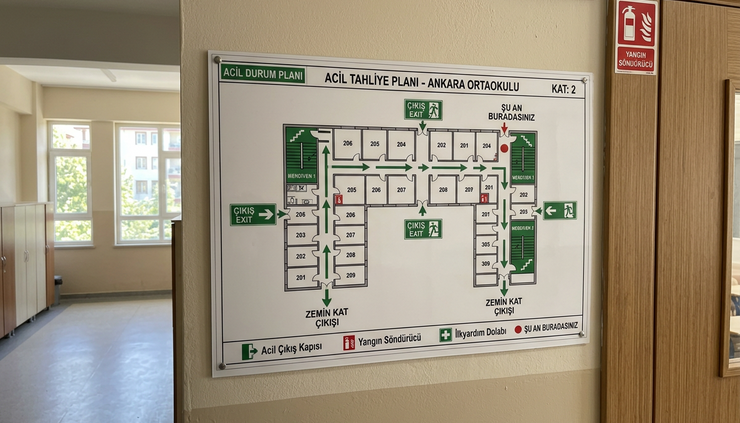Close-up view of a wall mounted evacuation route map in a school corridor