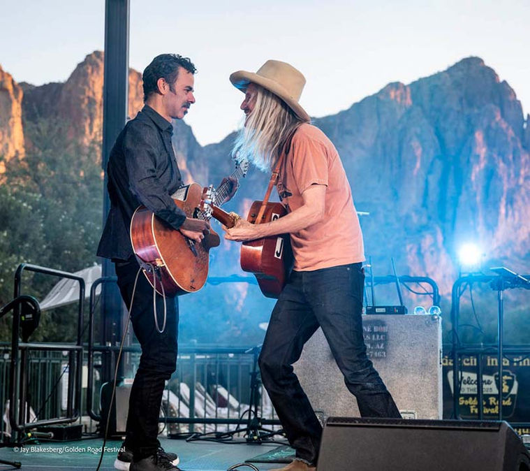 Two musicians playing acoustic guitars at Golden Road Festival