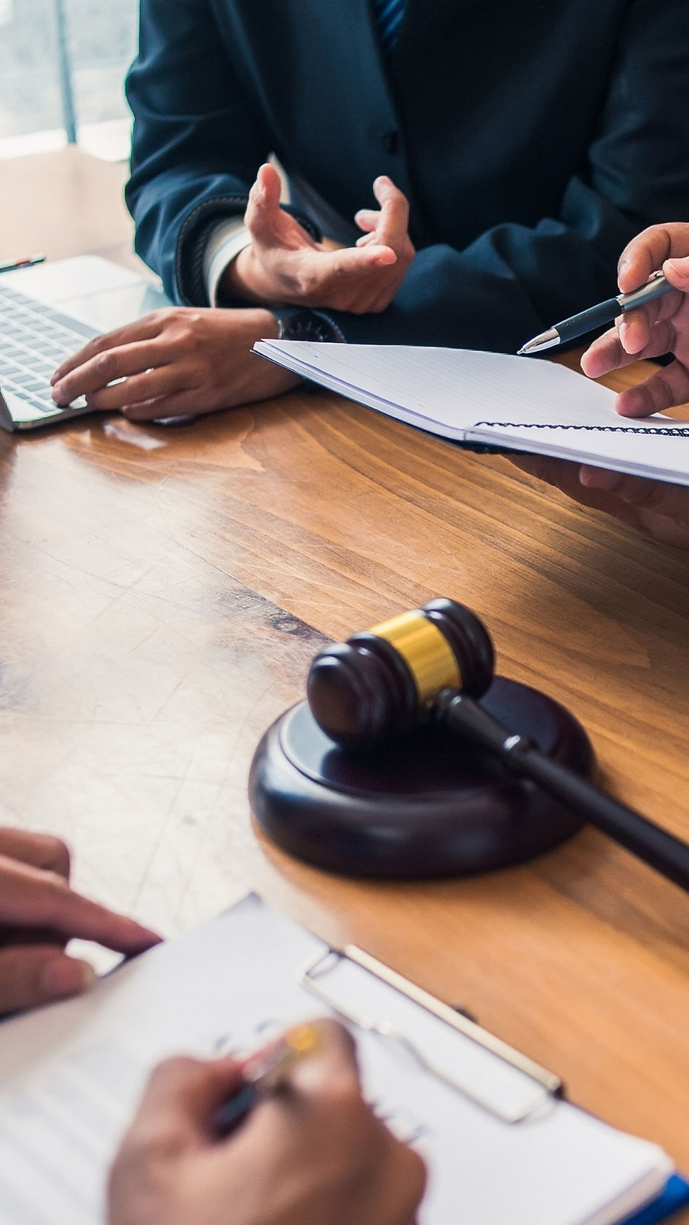 gavel on table with people negotiating