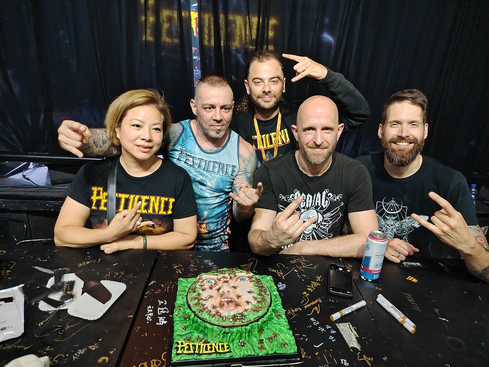 Musicians posing with elaborate Pestilence Consvming Impvlse album cover cake backstage