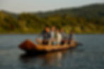Group of people enjoying a canoe tour on the Klamath River in Yurok Country, paddling a traditional Yurok dugout canoe.
