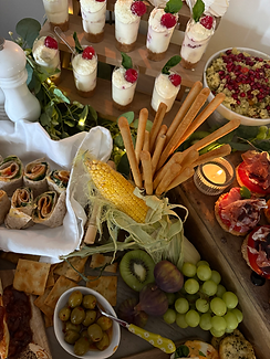 Buffet table with a variety of seasonal dishes, beautifully arranged for a celebration.