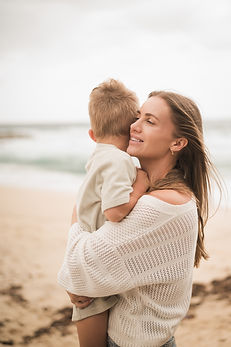 A mum hugging her son at Tamarama Beach